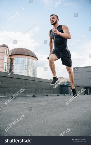 stock-photo-low-angle-view-of-handsome-sportsman-running-and-listening-music-with-smartphone-on-roof-1141839632.jpg